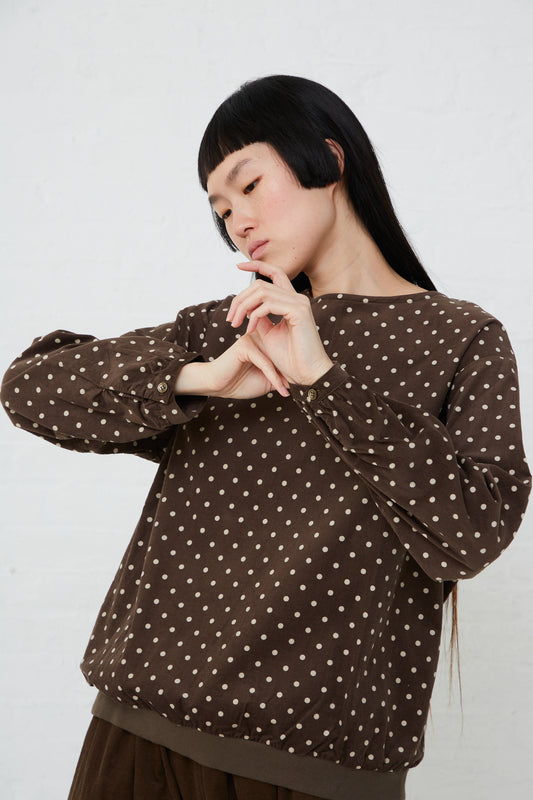 A woman wearing an Ichi Cotton Polk Dot Pullover in Brown sweater.