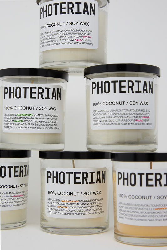 Five jars of Votive Coconut Soy Candles with brand name Photerian on them. Stacked.