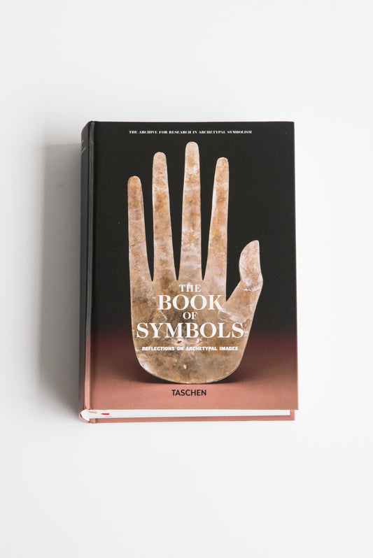 The cover of "The Book of Symbols: Reflections on Archetypal Images" from the Archive for Research in Archetypal Symbolism showcases a large stone hand, an archetypal symbol against a gradient background, evoking the collective unconscious.