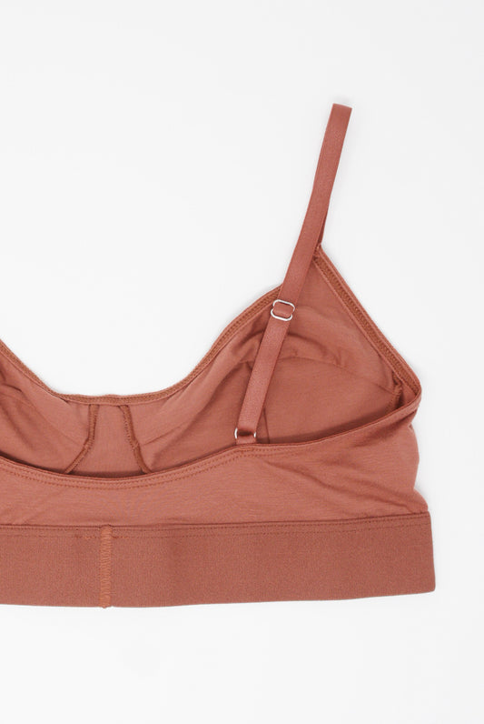 A supportive Soft Bra in Burned Red with straps on a white background by Baserange.
