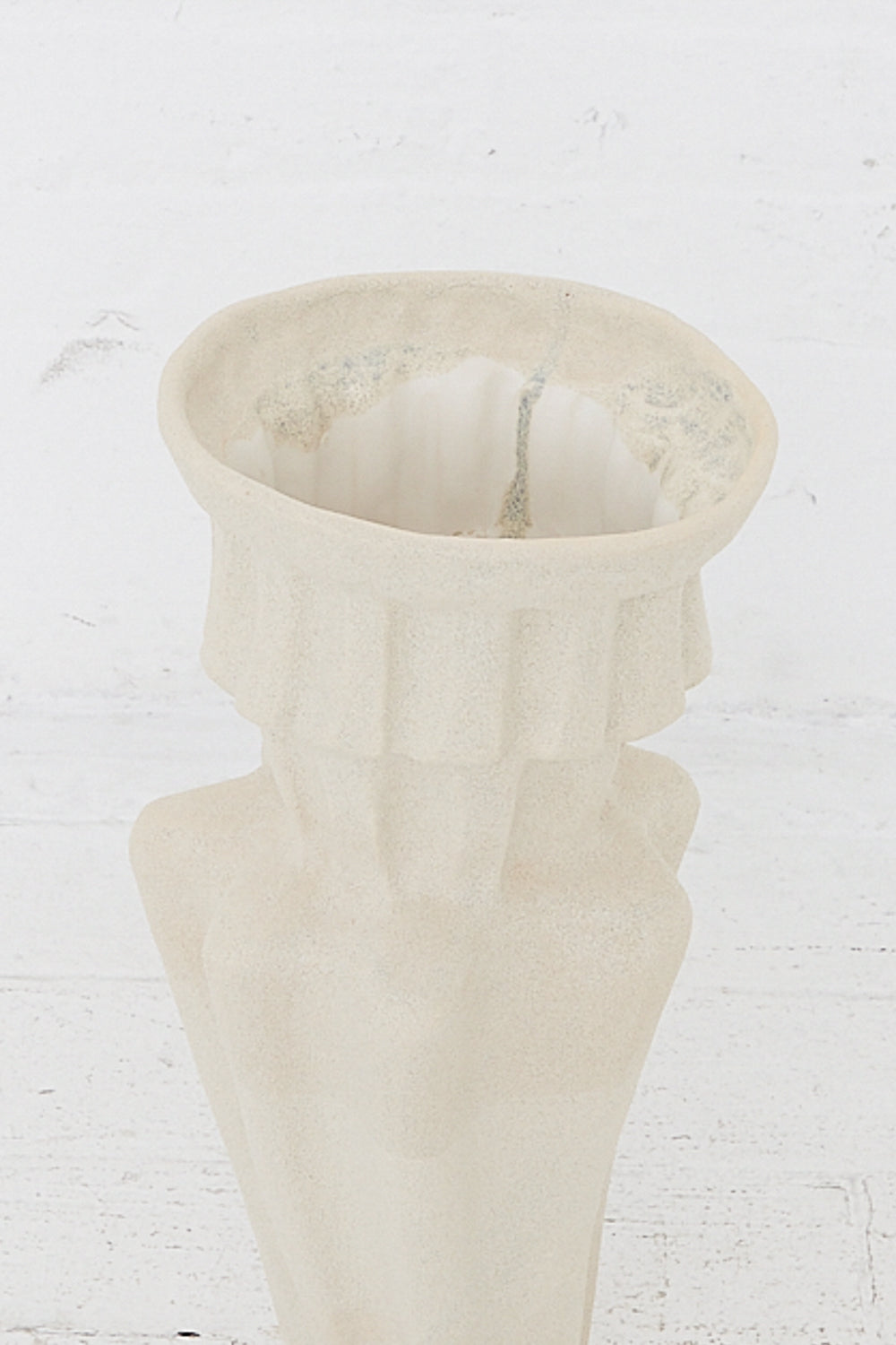 A white, hand-built ANK Ceramics Column Vessel in White with a white glaze sitting on a wooden table.