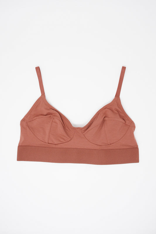 A supportive Soft Bra in Burned Red by Baserange on a white background.