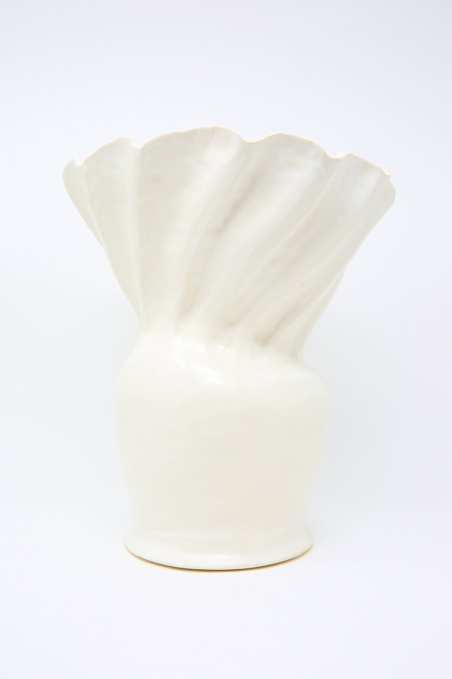 Pleat Vase in White by ANK Ceramics, a white stoneware piece with a fan-shaped top adorned with a satin white glaze, showcased against a plain background.