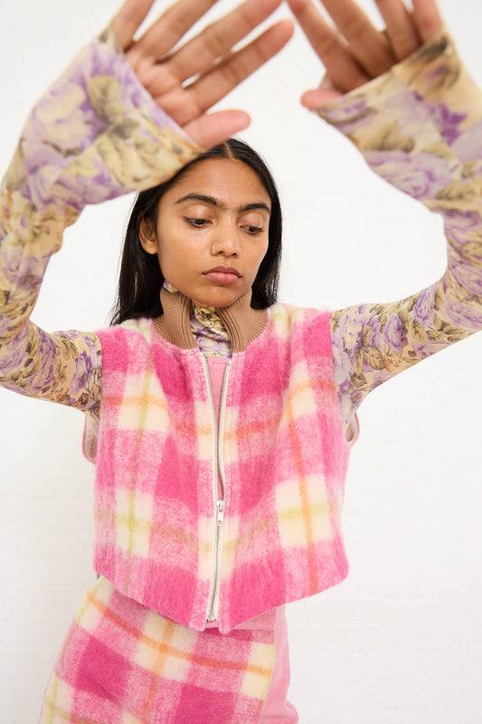 A person wearing the AVN Cool Bomber Jacket in White, Pink, and Green Check raises their arms in front of a plain white background.