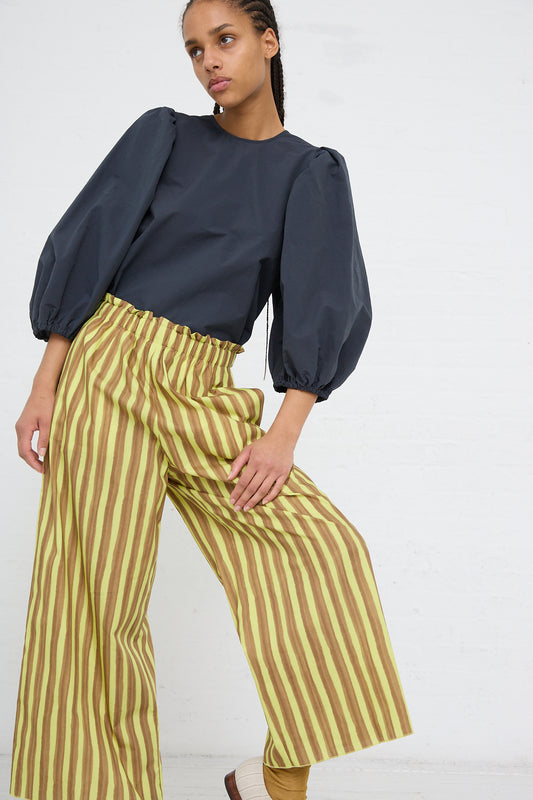 Woman posing in a grey blouse and AVN Easy Pant in Brown and Yellow Stripes.