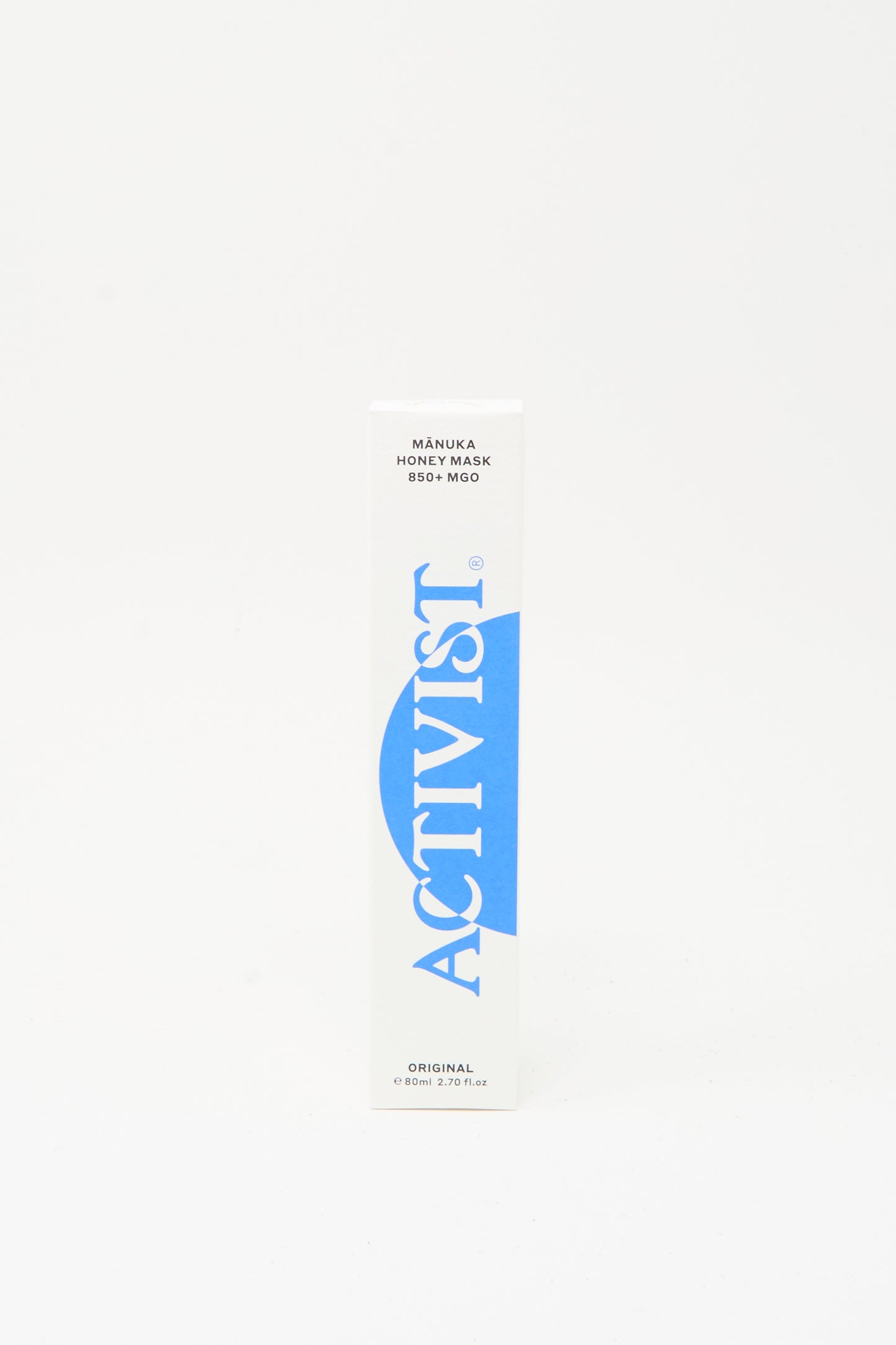 A white rectangular box labeled "Activist" in blue with "Mānuka Honey Mask" and "Original" text, highlighting its natural healing Mānuka honey, sits on a plain white background.