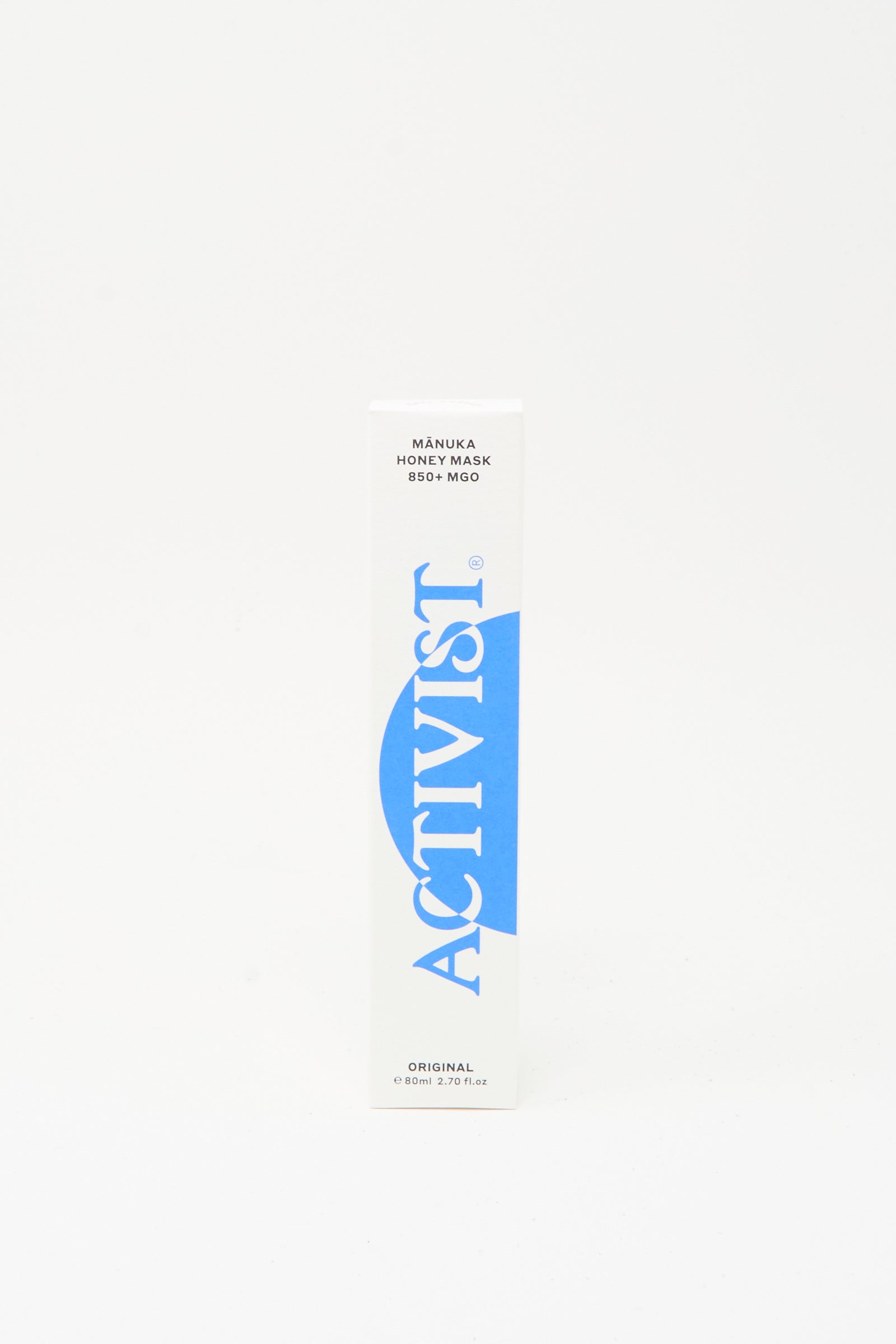 A white rectangular box labeled "Activist" in blue with "Mānuka Honey Mask" and "Original" text, highlighting its natural healing Mānuka honey, sits on a plain white background.