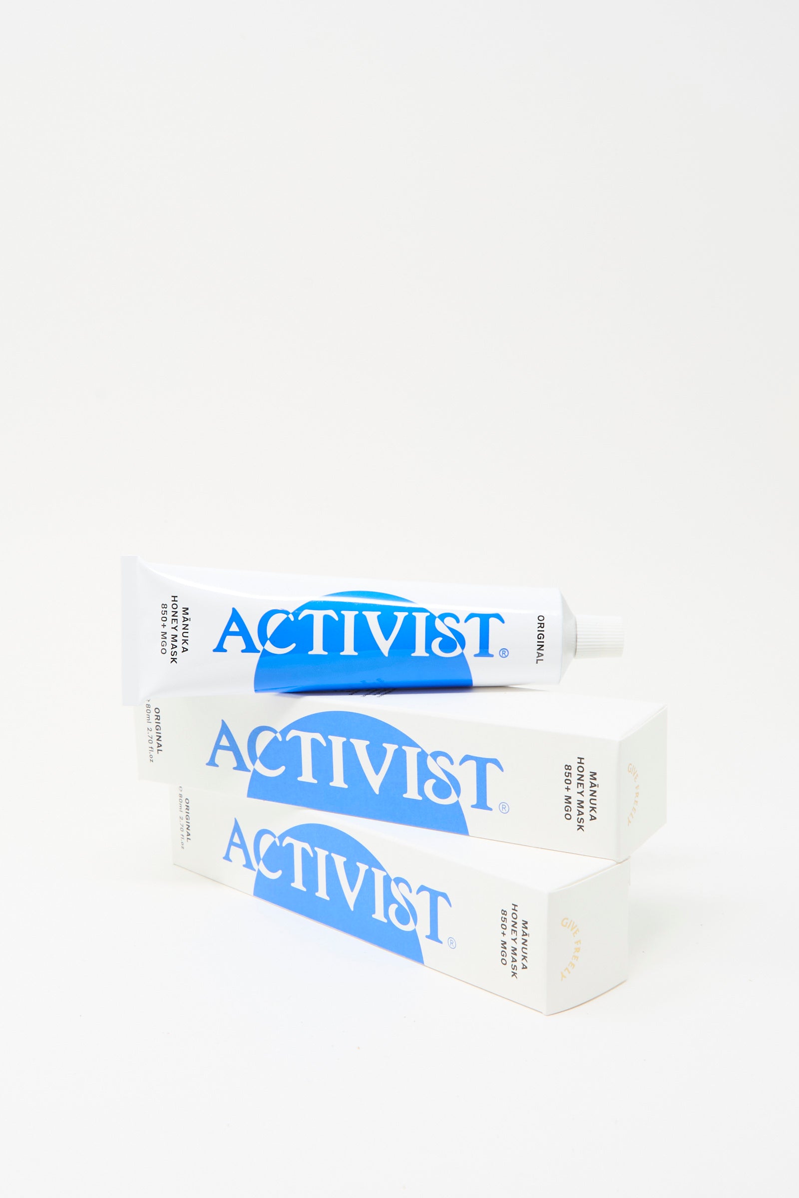 A jar of Activist Mānuka Honey Mask sits atop two stacked Activist boxes, set against a plain white background.