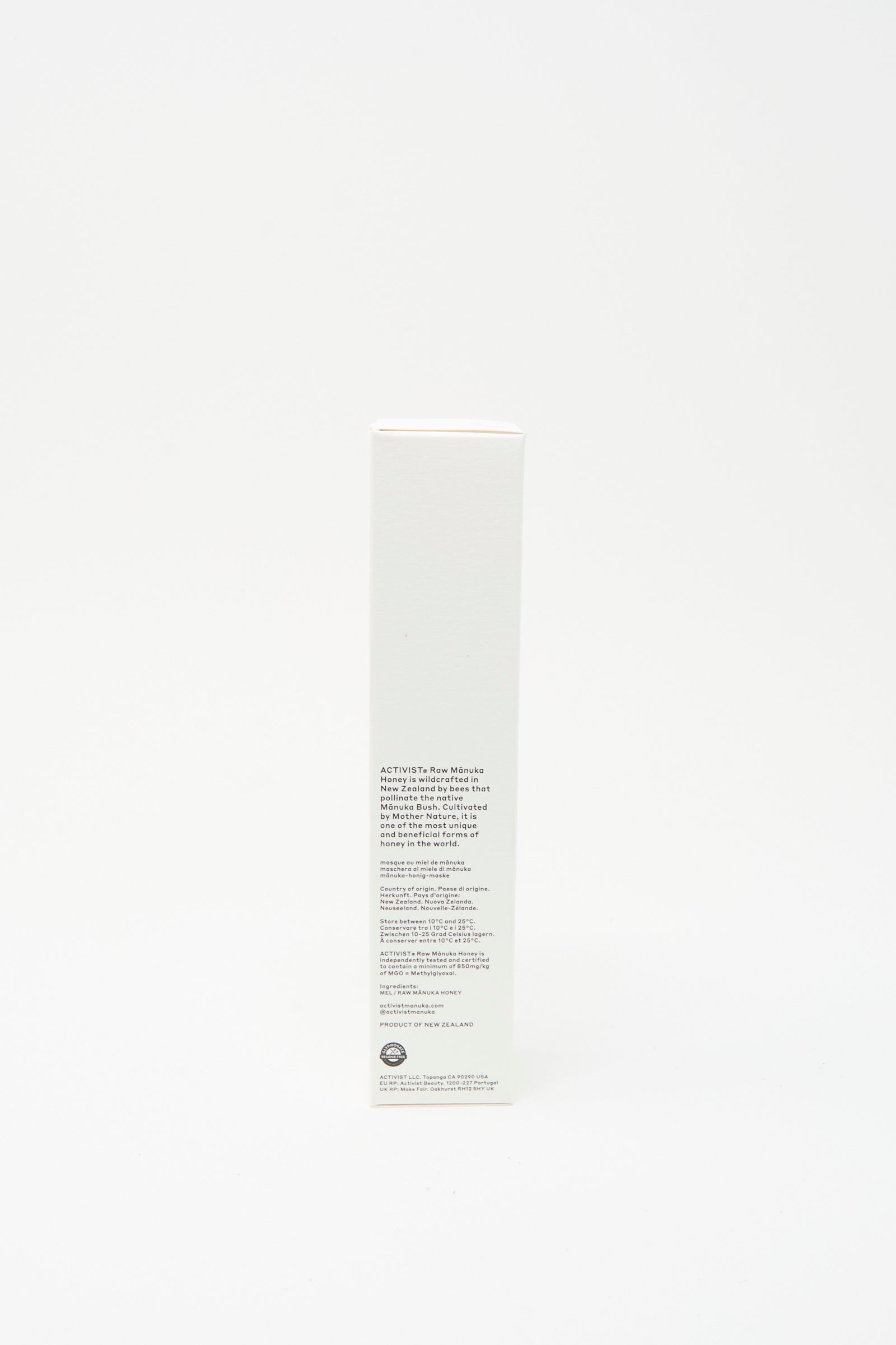 A tall, rectangular white box stands upright against a plain background, featuring printed text and the Activist logo—ideal for highlighting the Activist Mānuka Honey Mask that supports natural skin healing.