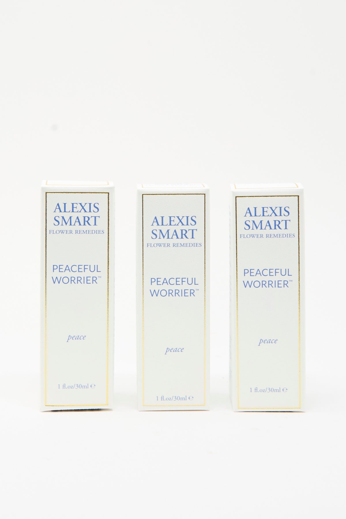 Three identical white rectangular boxes of Alexis Smart Flower Remedies Peaceful Worrier organic flower essences with blue text and gold trim.