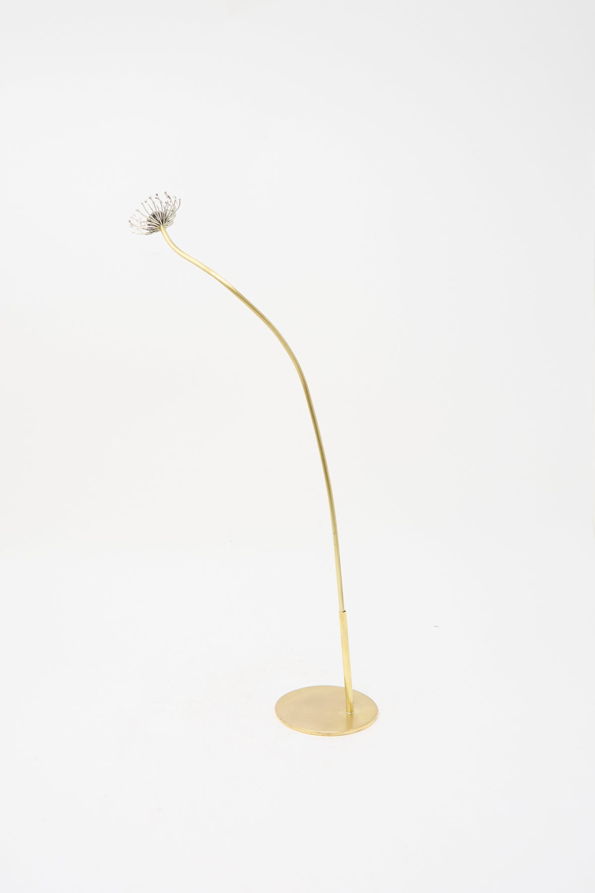 Alison Layton Sterling Silver and Brass Papaver No. 12 - II: a tall, slender brass flower sculpture with a silver seed head on a circular base.