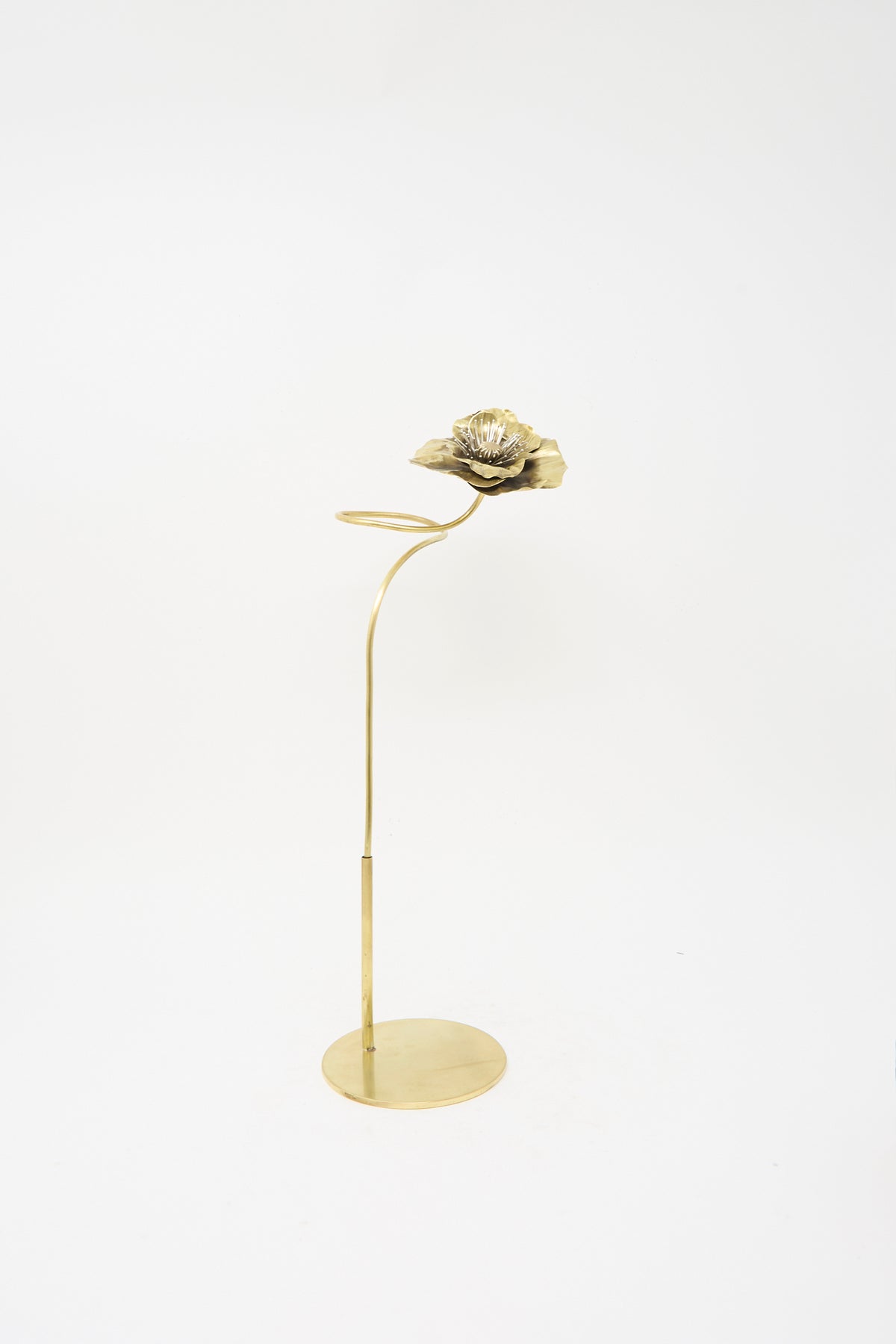 A handmade Sterling Silver and Brass Papaver No. 7 - I metal sculpture of a poppy on a tall, thin stand with a circular base.