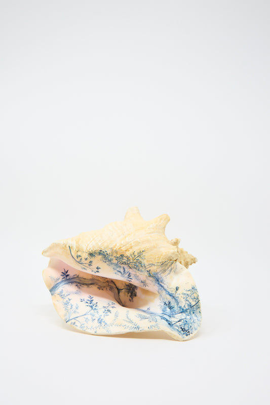 A Hand Painted Conch III from Alyssa Goodman, featuring intricate blue designs that depict trees and a landscape, showcasing hand-painted artistry.