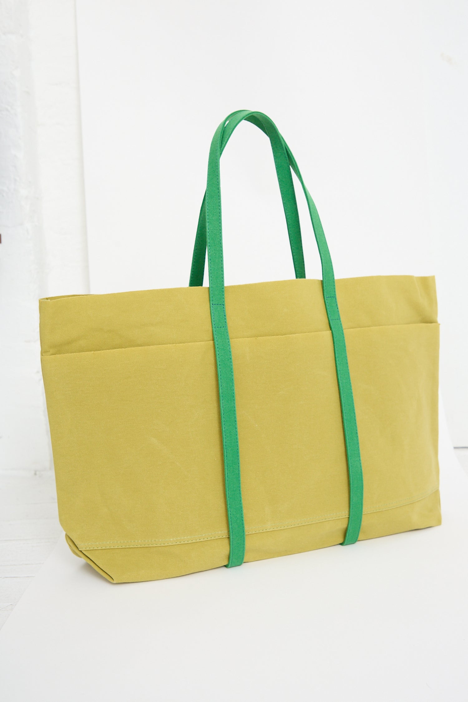 Light Ounce Canvas Tote in Lime and Green by Amiacalva against a white background.