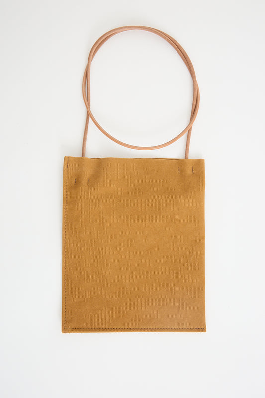 A simple brown Amiacalva Washed Canvas Pochette in Mustard against a white background.