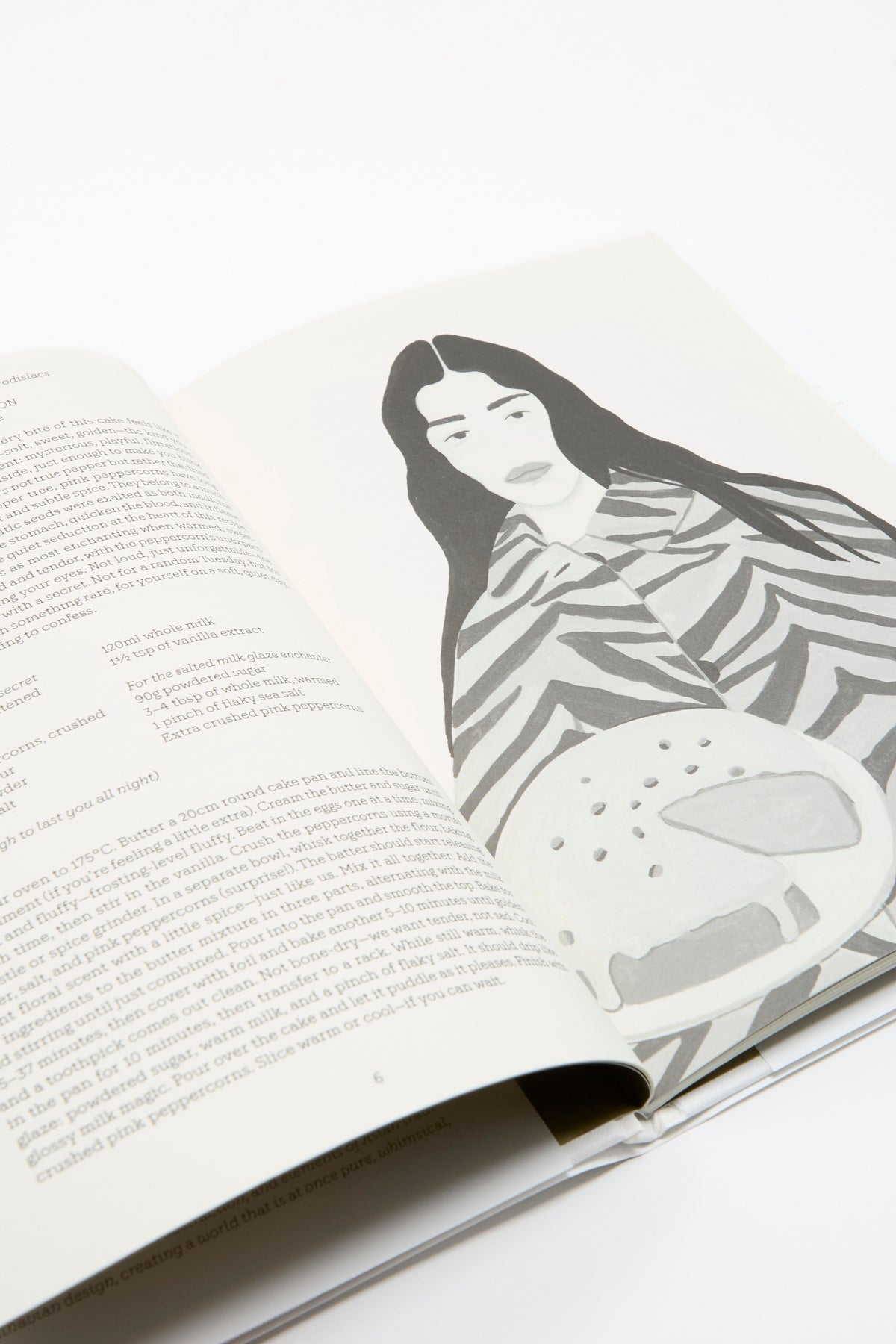 Open Apartamento Cookbook #10: Aphrodisiacs showing a recipe and a stylized illustration of a woman holding an aphrodisiac cake.