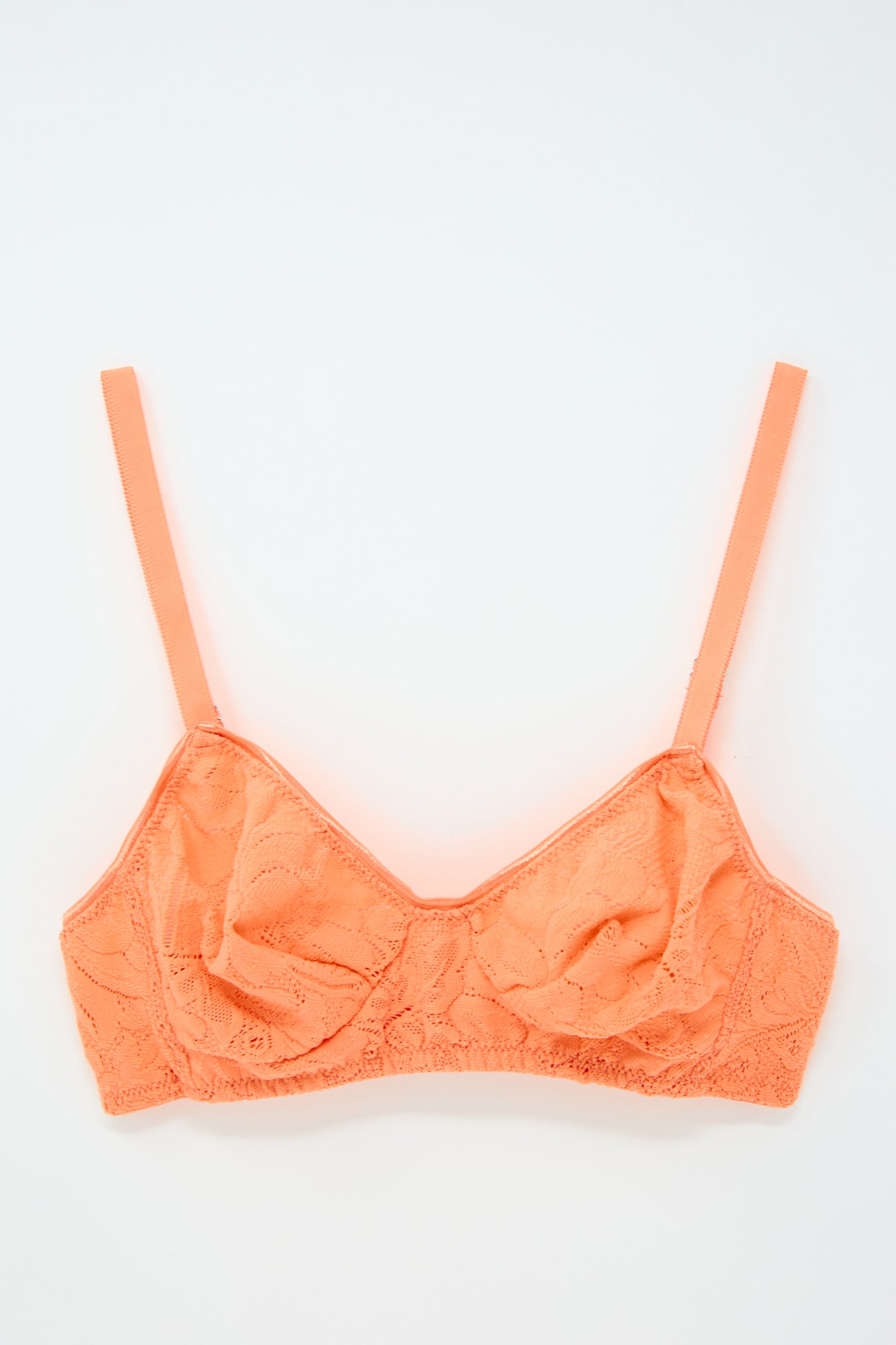 The Tamara Bralette in Lush from Araks, made from delicate French stretch lace and featuring thin adjustable straps and a V-neckline, laid flat on a white background.