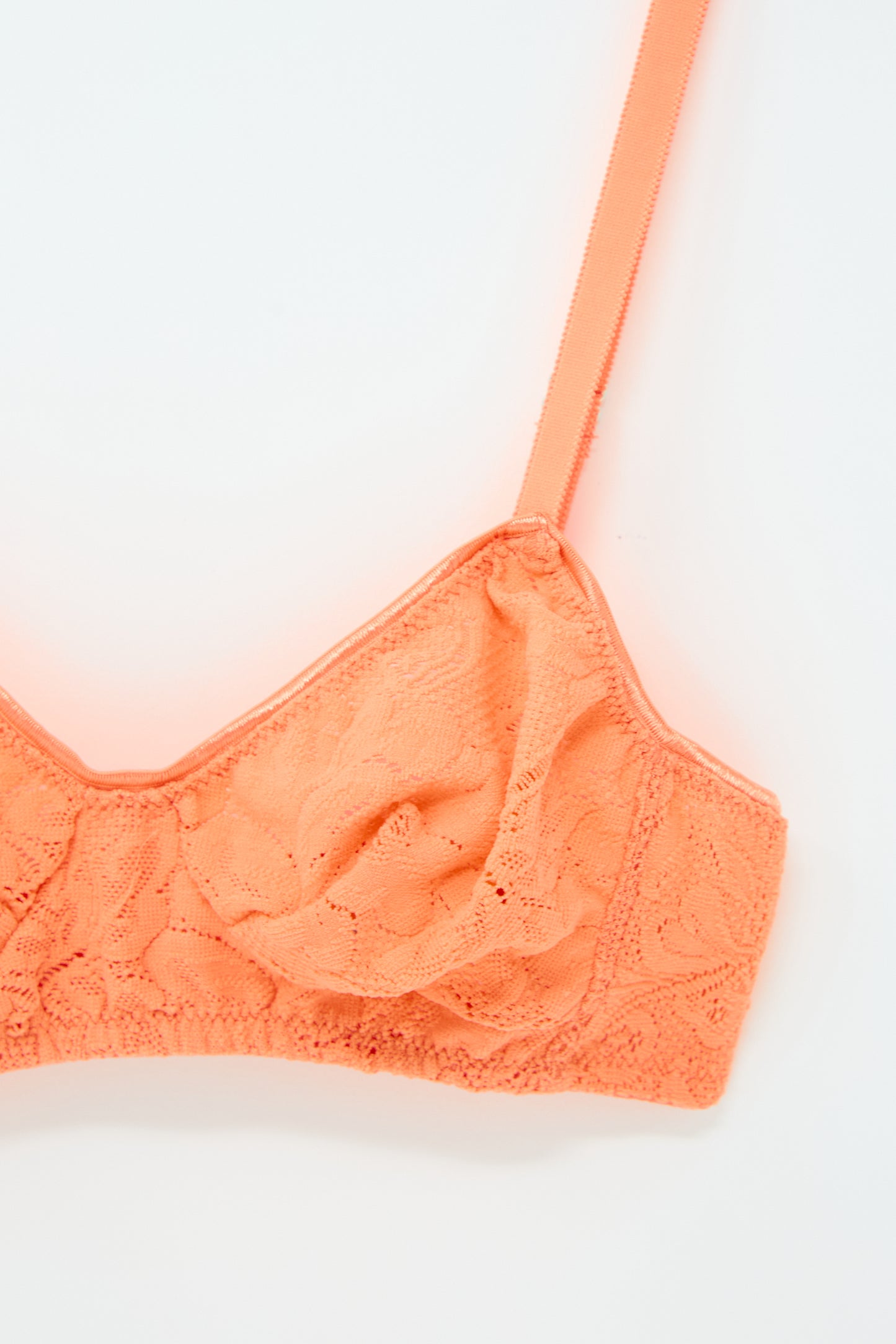 Close-up of the Tamara Bralette in Lush by Araks made from French stretch lace, with adjustable straps, on a white background.