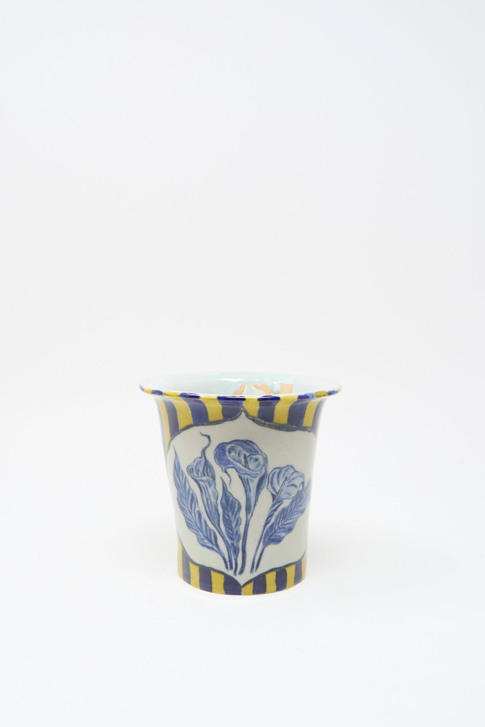 The Ariel Clute Hand Painted Floral Vessel is handmade in California from porcelain, featuring yellow and blue vertical stripes with a bold blue floral design on the front, photographed on a plain white background.