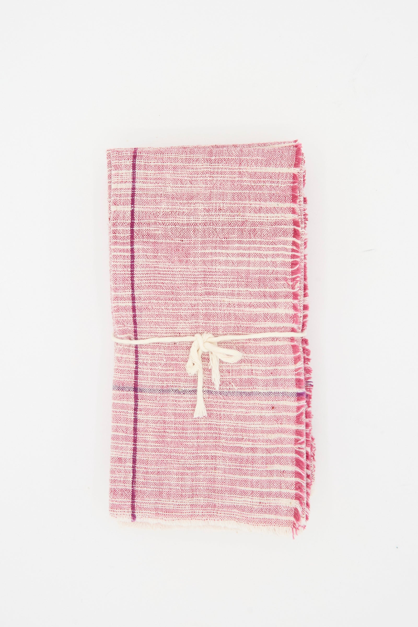 Auntie Oti's Cotton Khadi Set of 6 Napkins in Pink Space Dye features handwoven pink and white napkins with fringed edges, tied with a cream string and placed against a white background.