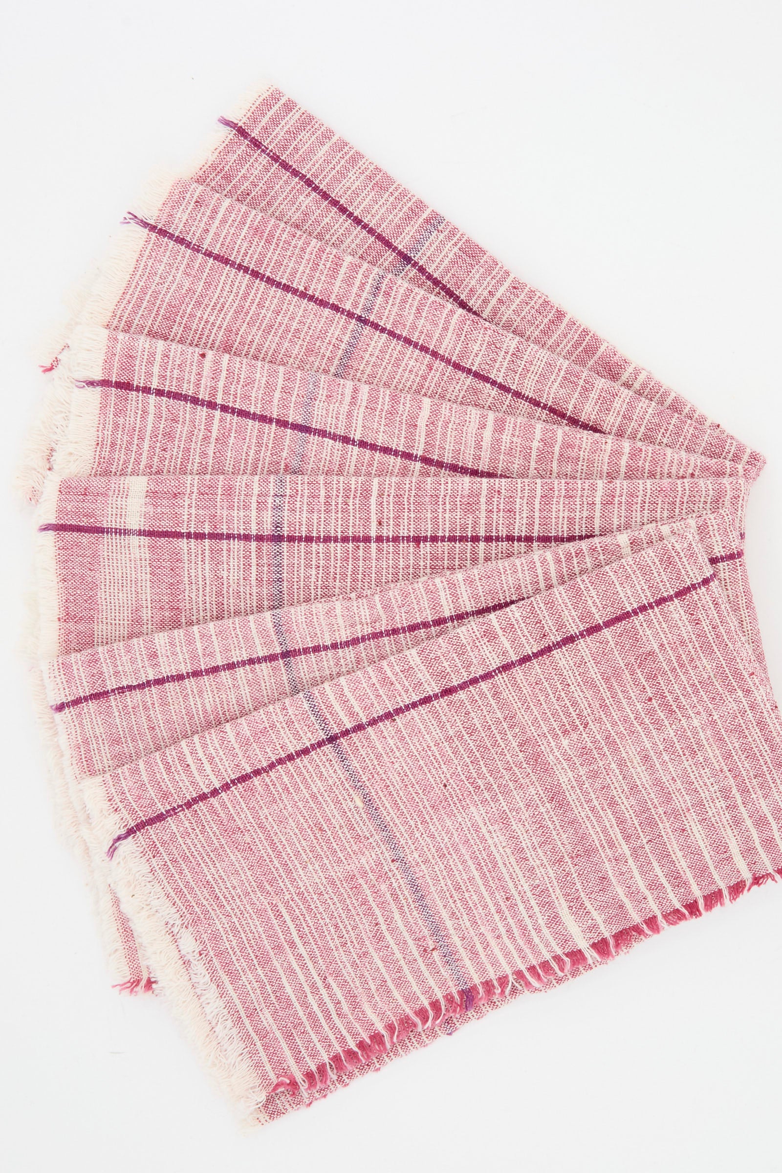 The Auntie Oti Cotton Khadi Set of 6 Napkins in Pink Space Dye features handwoven rectangular napkins with fringed edges, arranged on a white background.