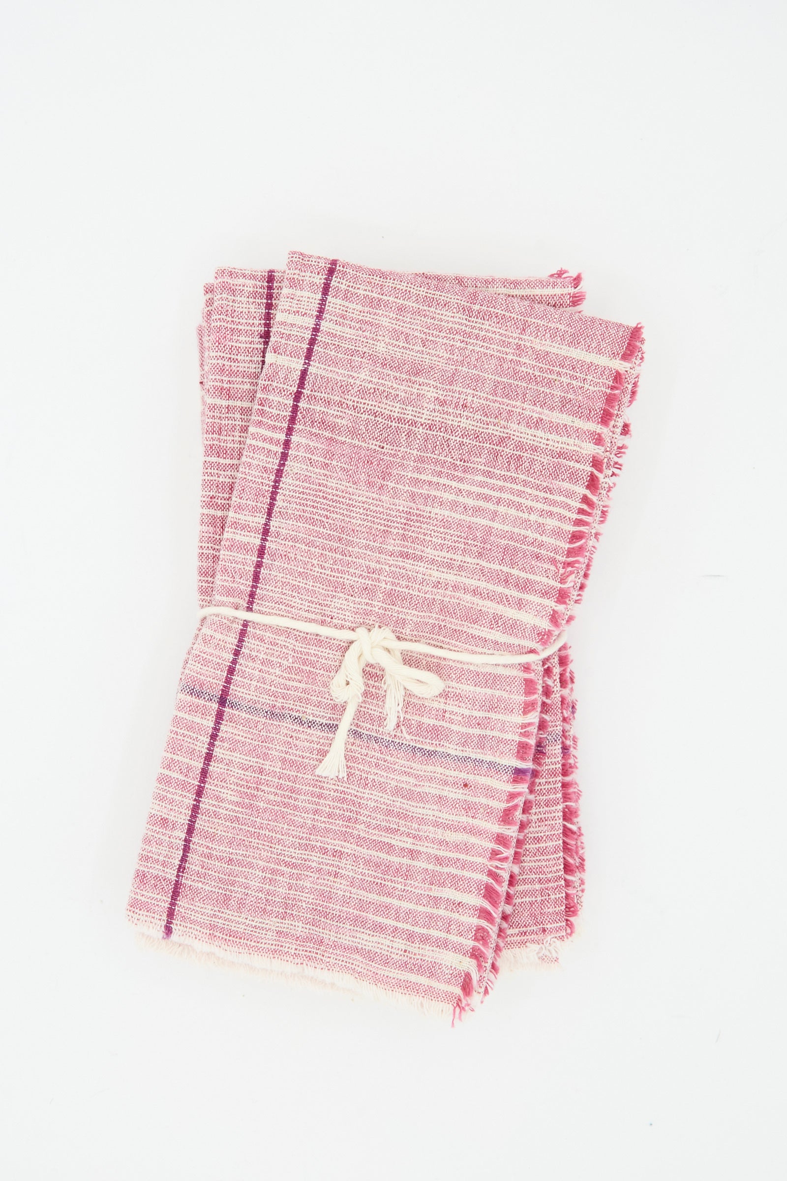 Auntie Oti's Cotton Khadi Set of 6 Napkins in Pink Space Dye is bundled together with white string and displayed on a white background.