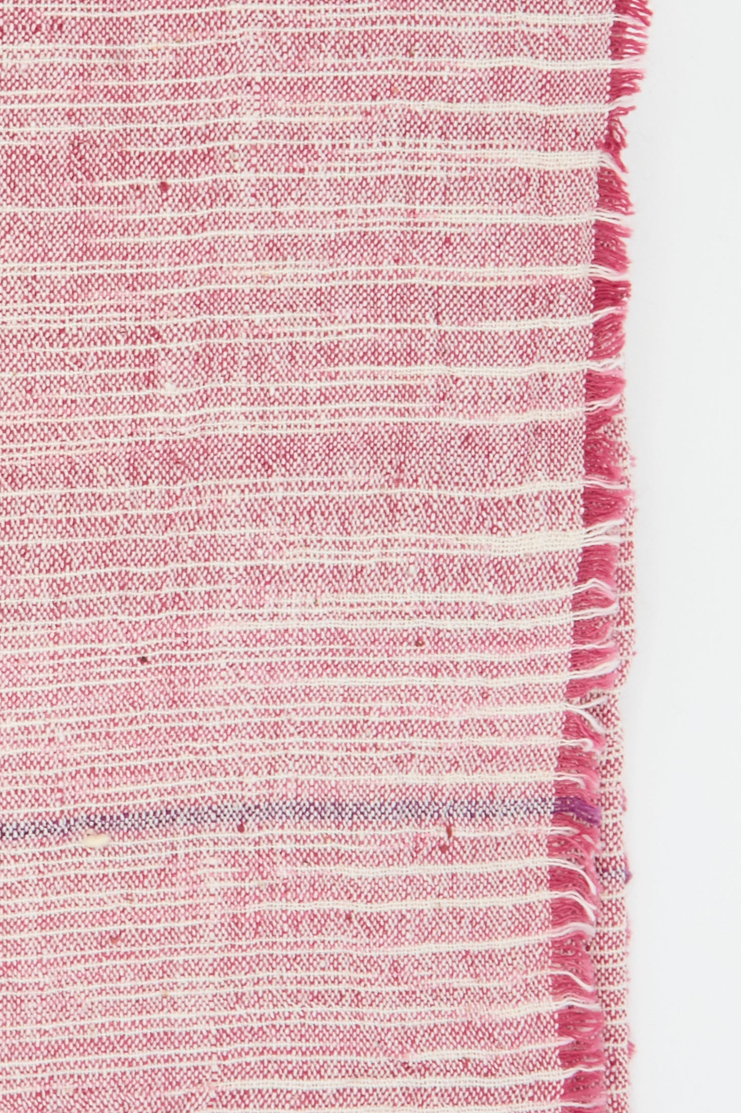 Close-up of an Auntie Oti Cotton Khadi Set of 6 Napkins in Pink Space Dye, featuring pink and white stripes with a fringed right edge.