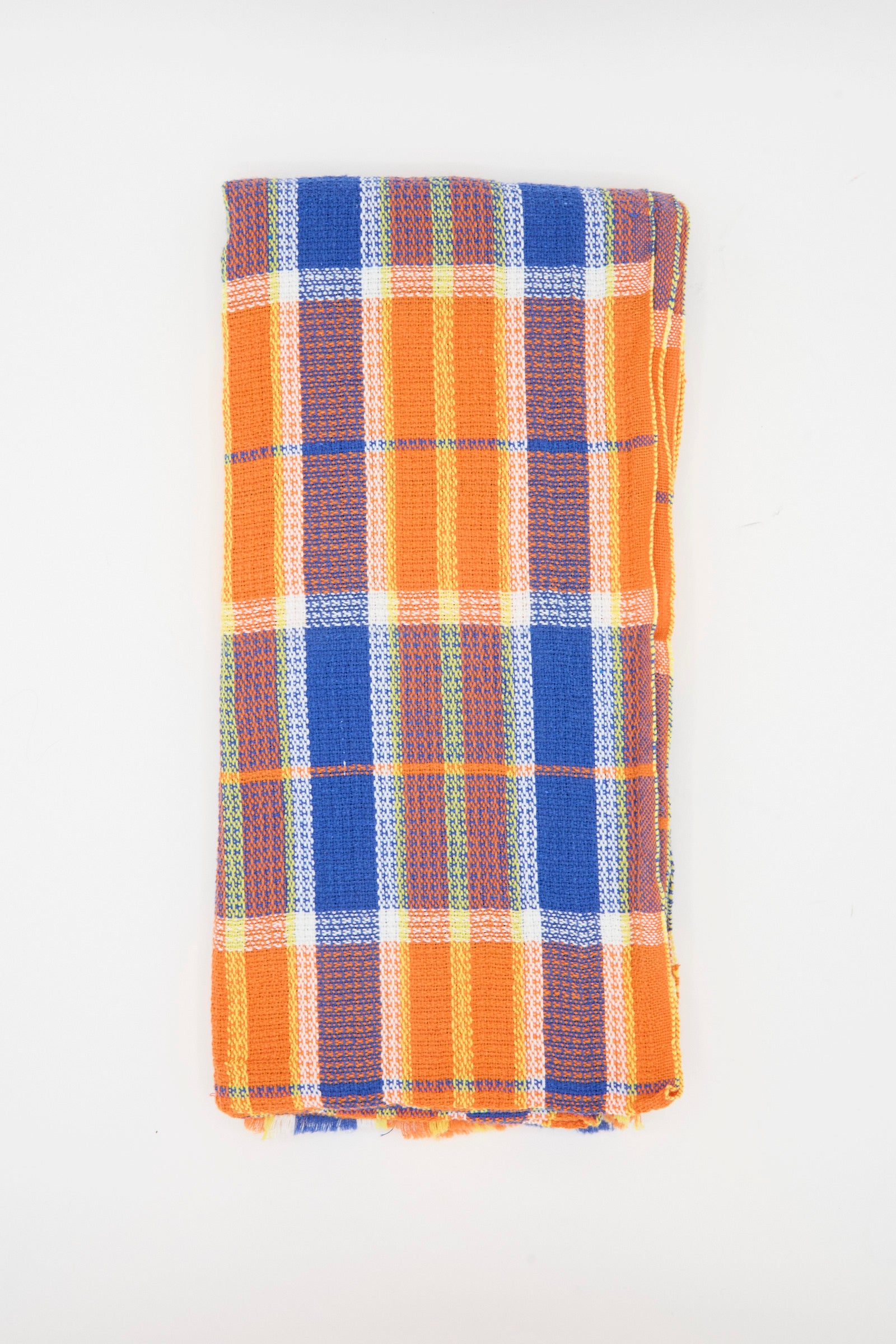 The Auntie Oti Dobby Plaid Towel in Orange and Blue is a handwoven, rectangular kitchen towel featuring orange, blue, white, and green plaid on a plain white background.