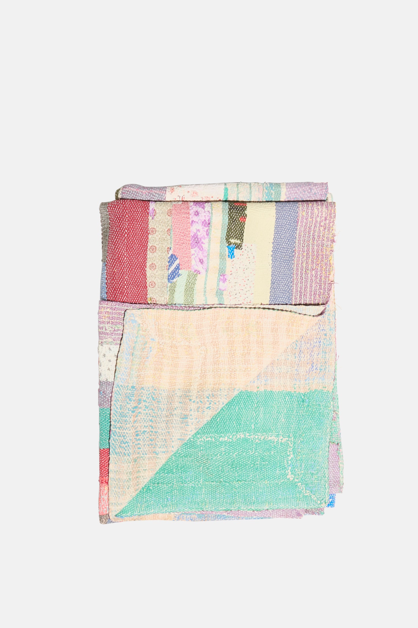 The One of a Kind Vintage Kantha Quilt I by Auntie Oti is a folded, multicolored quilt crafted from upcycled cotton, featuring pastel and muted geometric patchwork designs.