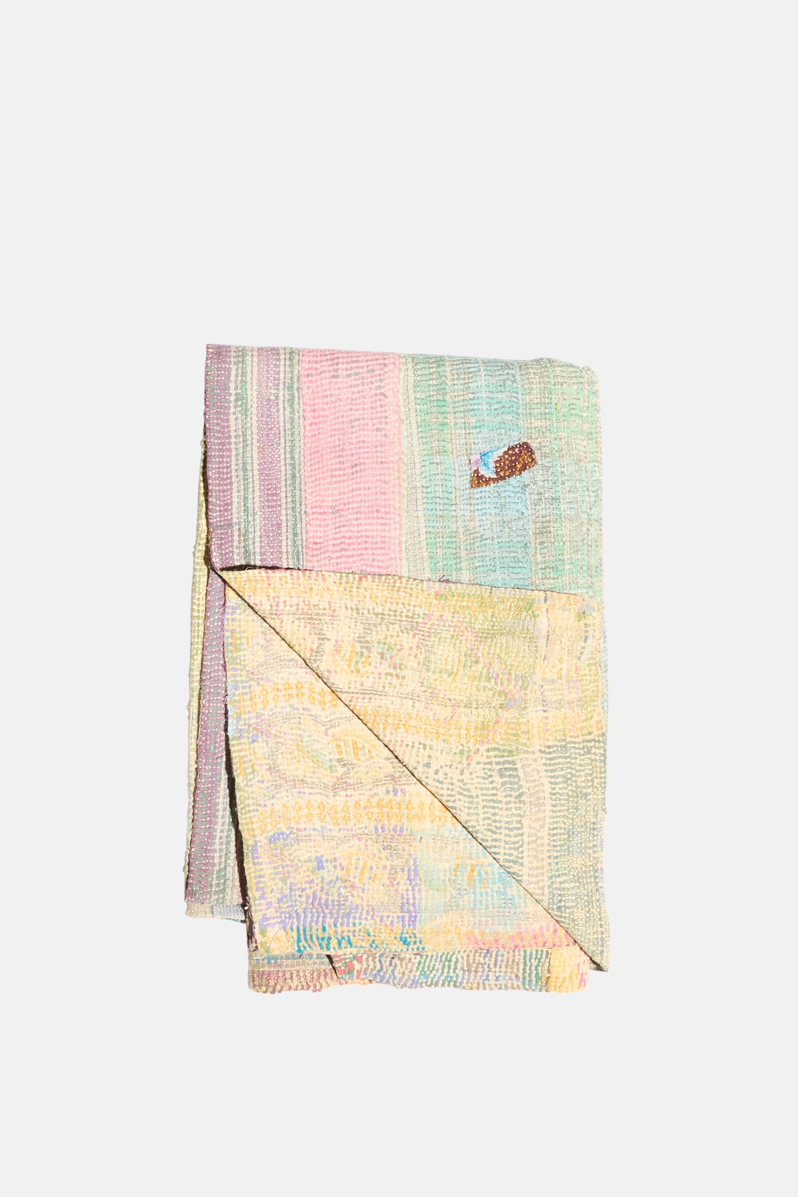 The One of a Kind Vintage Kantha Quilt III by Auntie Oti features vertical pastel patchwork stripes and a small fish patch near the top right, crafted from soft upcycled cotton.