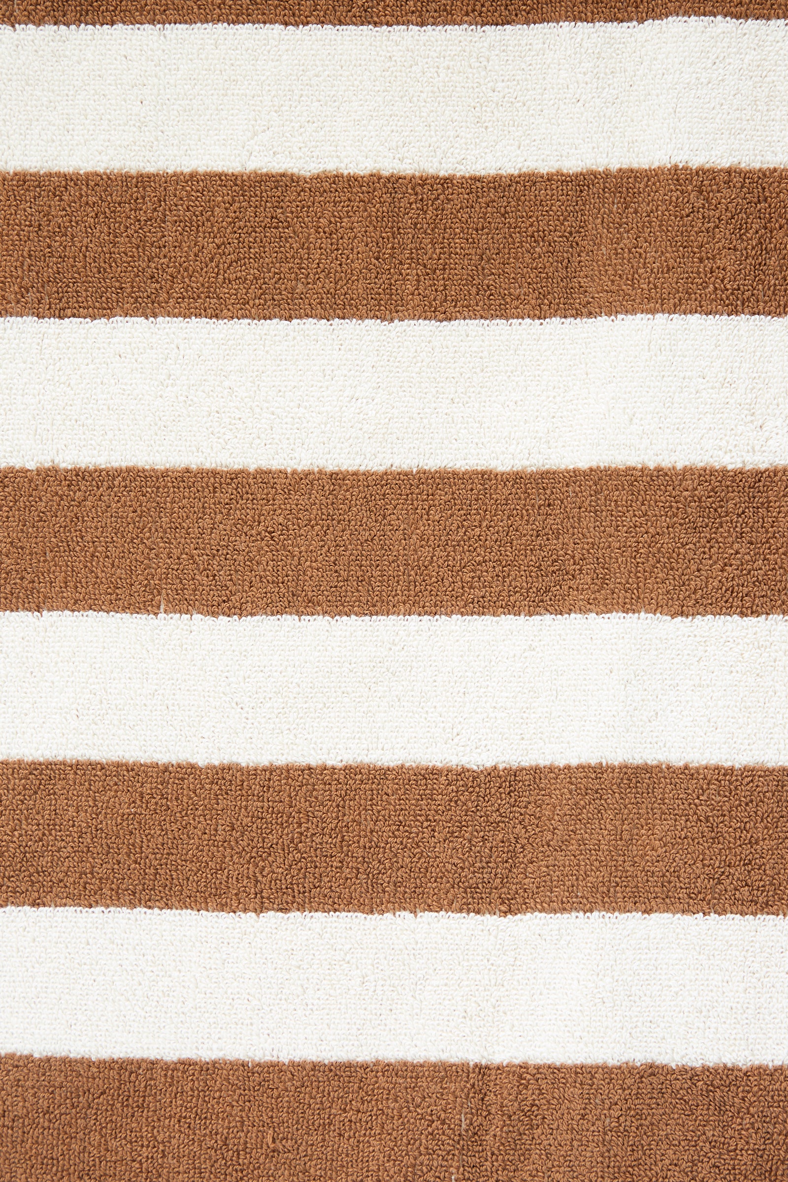 Close-up of an oversized Maria Pool Towel made with organic cotton, featuring alternating horizontal brown and white stripes by Autumn Sonata.