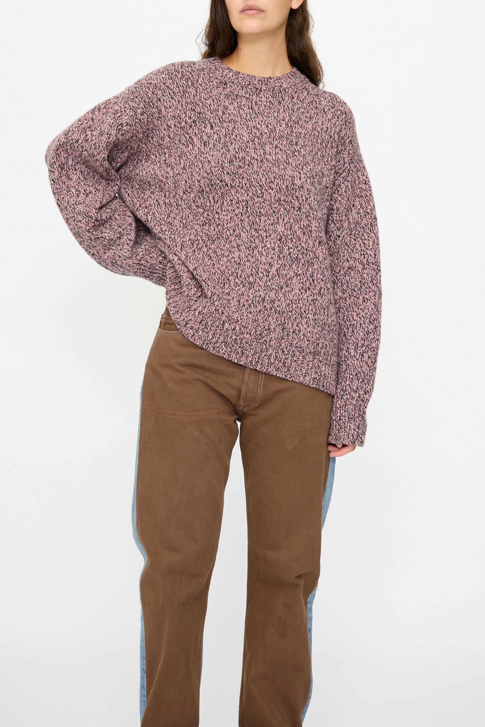 A person wears the B Sides Braided Lambswool Crew in Etowah Twist and brown pants, standing with one hand on their hip against a plain white background.