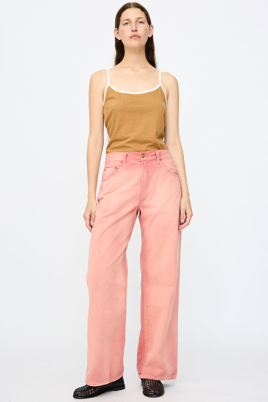 A woman faces forward wearing a brown tank top, B Sides Hobie Pant in Vintage Red (a relaxed fit, high-waisted chino cotton pant), and black shoes against a plain white background.