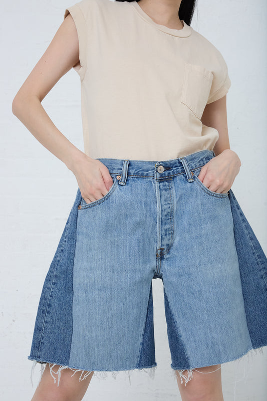 A woman in B Sides' Lasso Short in Vintage Indigo with a slouchy fit.
