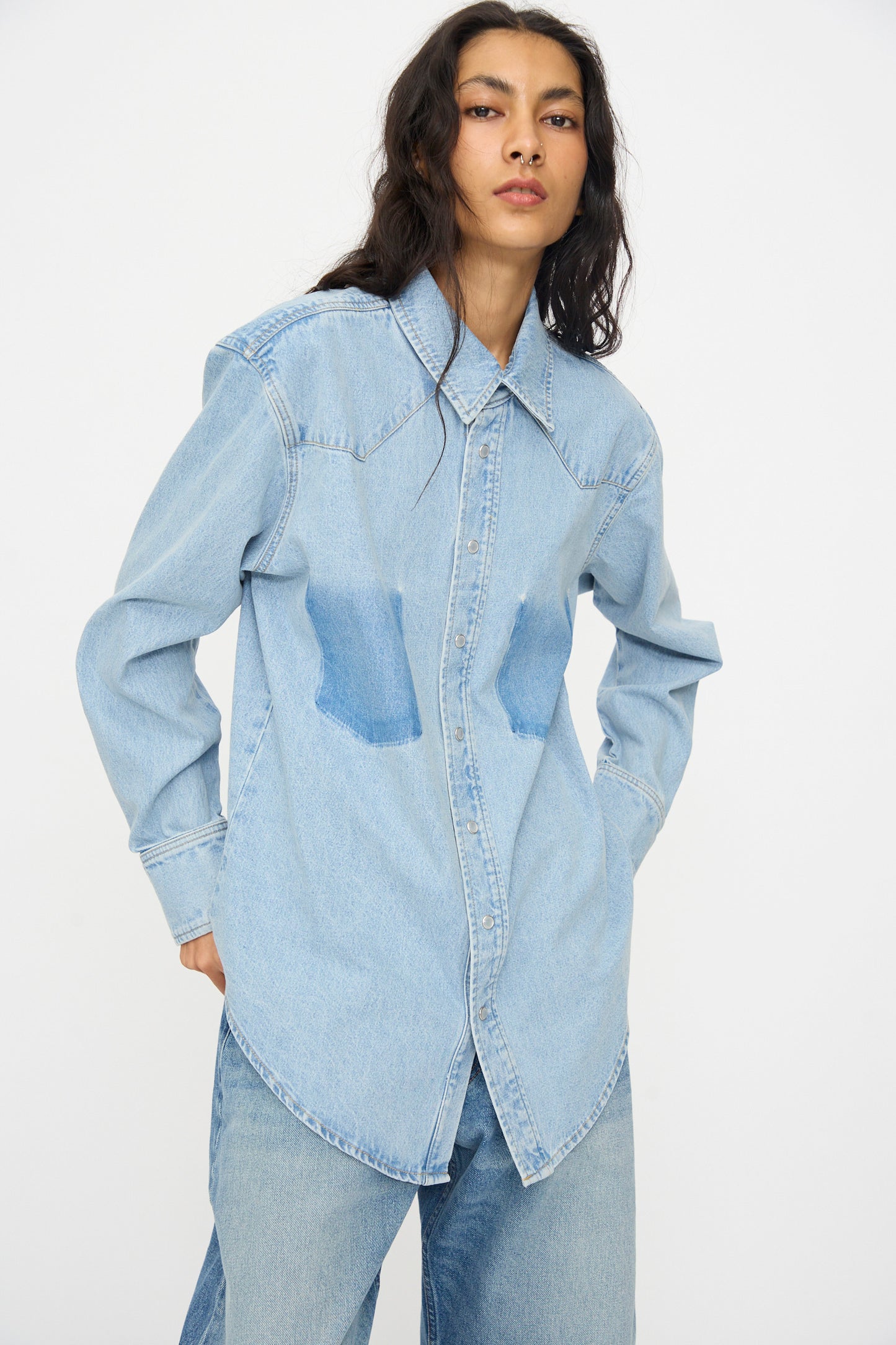 A person wearing the B Sides Liv Western Shirt in Park Wash with matching denim pants stands against a plain white background.