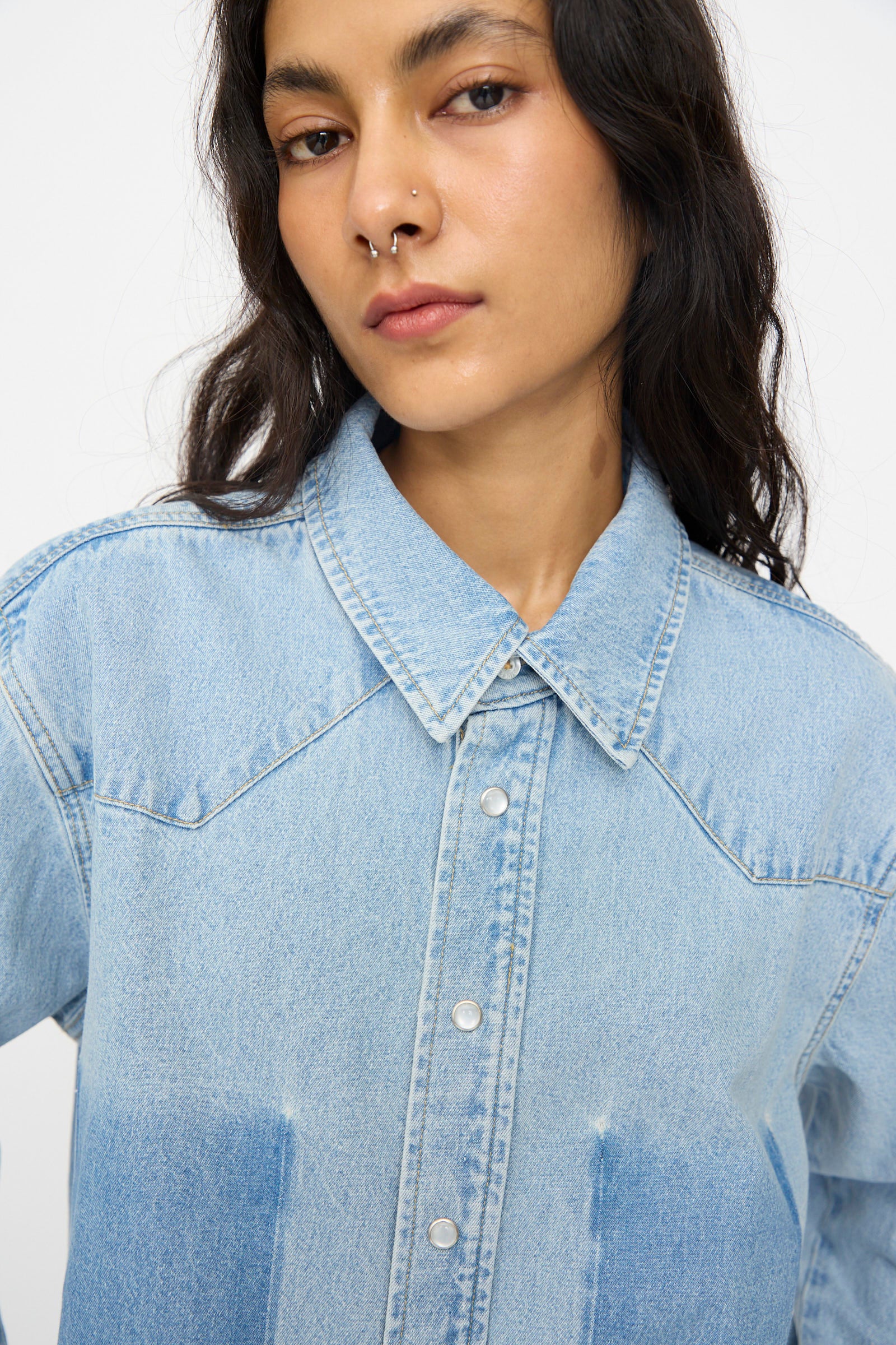 A person with long dark hair and a nose ring wears the B Sides Liv Western Shirt in Park Wash, looking directly at the camera against a plain background.