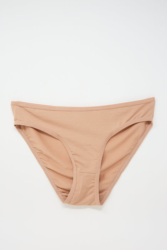A pair of beige Baserange Bamboo Bell Pant in Yu Rose, sustainably produced basics for women, displayed against a white background.