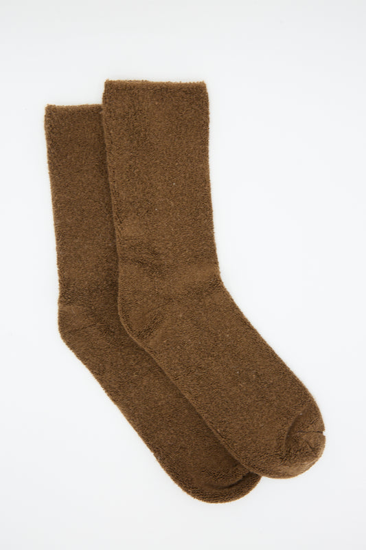 A pair of Baserange Buckle Overankle Socks in Brown laid flat on a white background.