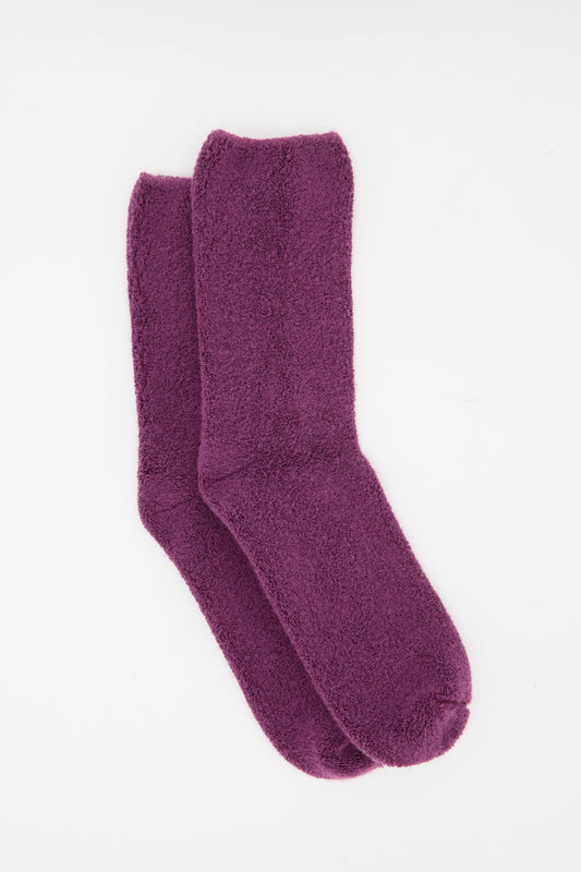 A pair of Baserange Buckle Overankle Socks in Gesso Purple, crafted from organic cotton, laid flat on a white background.