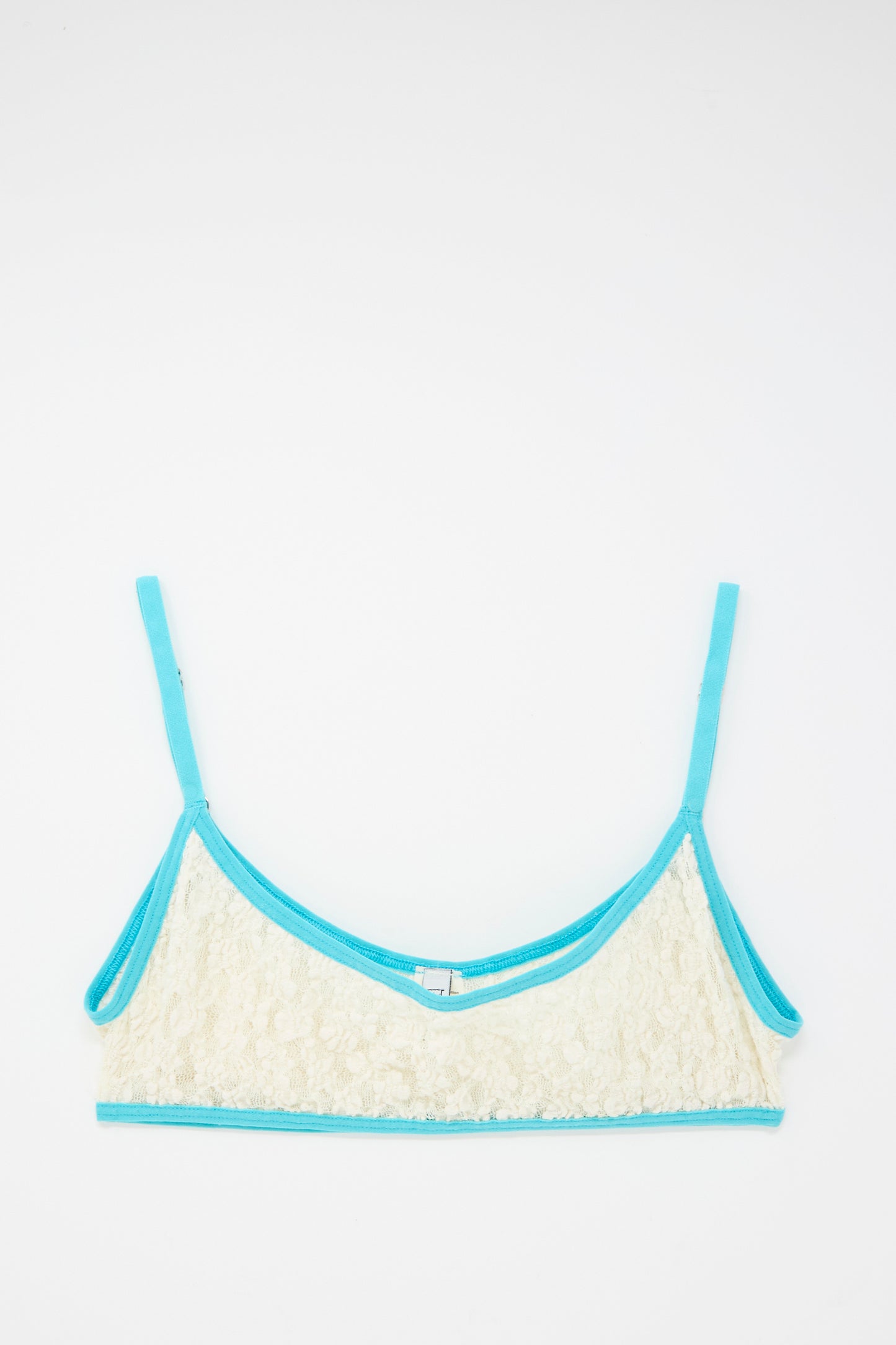 The Baserange Cotton Lace Musial Bra in Undyed and Turquoise features organic cotton with turquoise straps and blue trim, displayed flat on a white background.