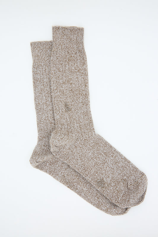 A pair of Baserange Cotton Rib Overankle Socks in Grey Brown Melange laid flat on a white background.