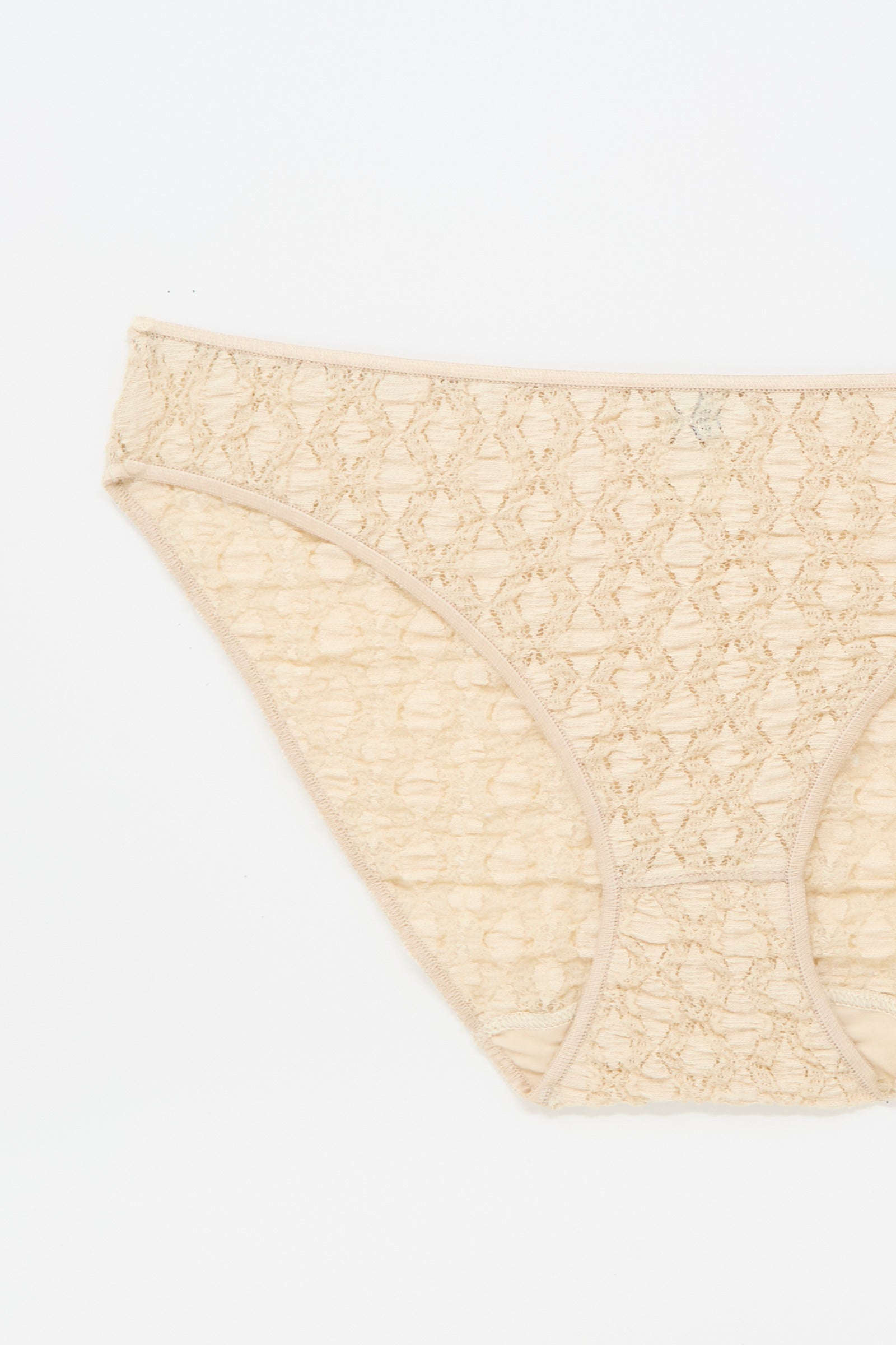 The Crescent Pants in Dylan Beige by Baserange, a beige cotton lace low-rise women's brief, is displayed flat on a white background, showing the front and partial side.