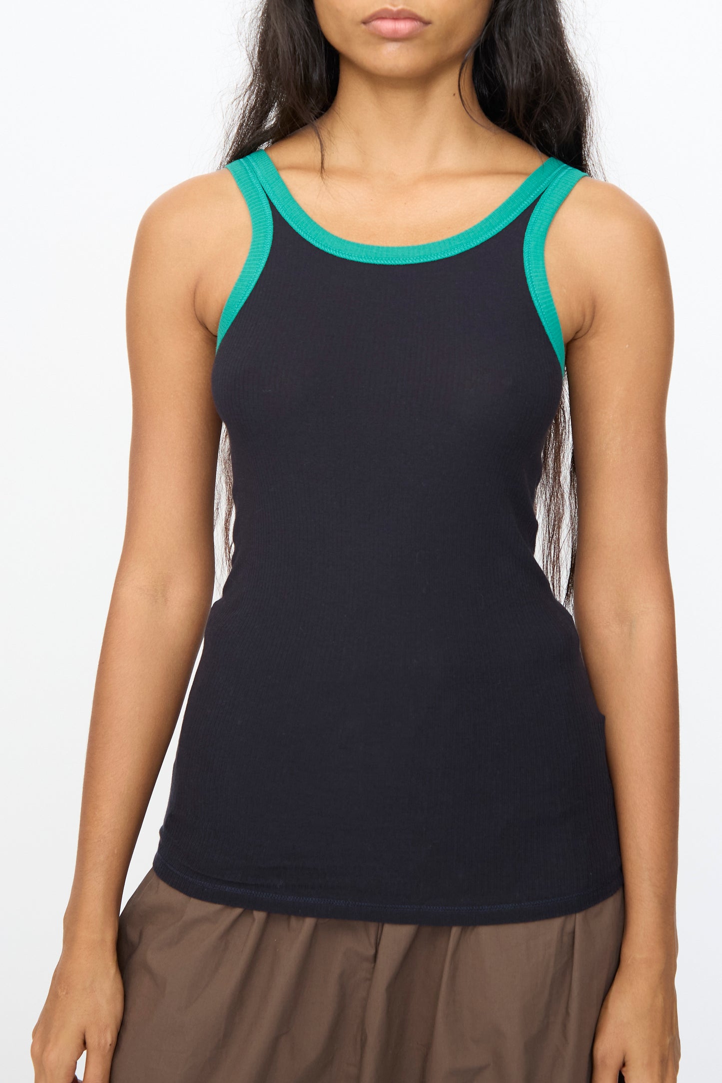 A person wearing the Baserange Drive Tank in Murano Navy, a slim fit sleeveless top, shown from the shoulders to the waist against a plain background.