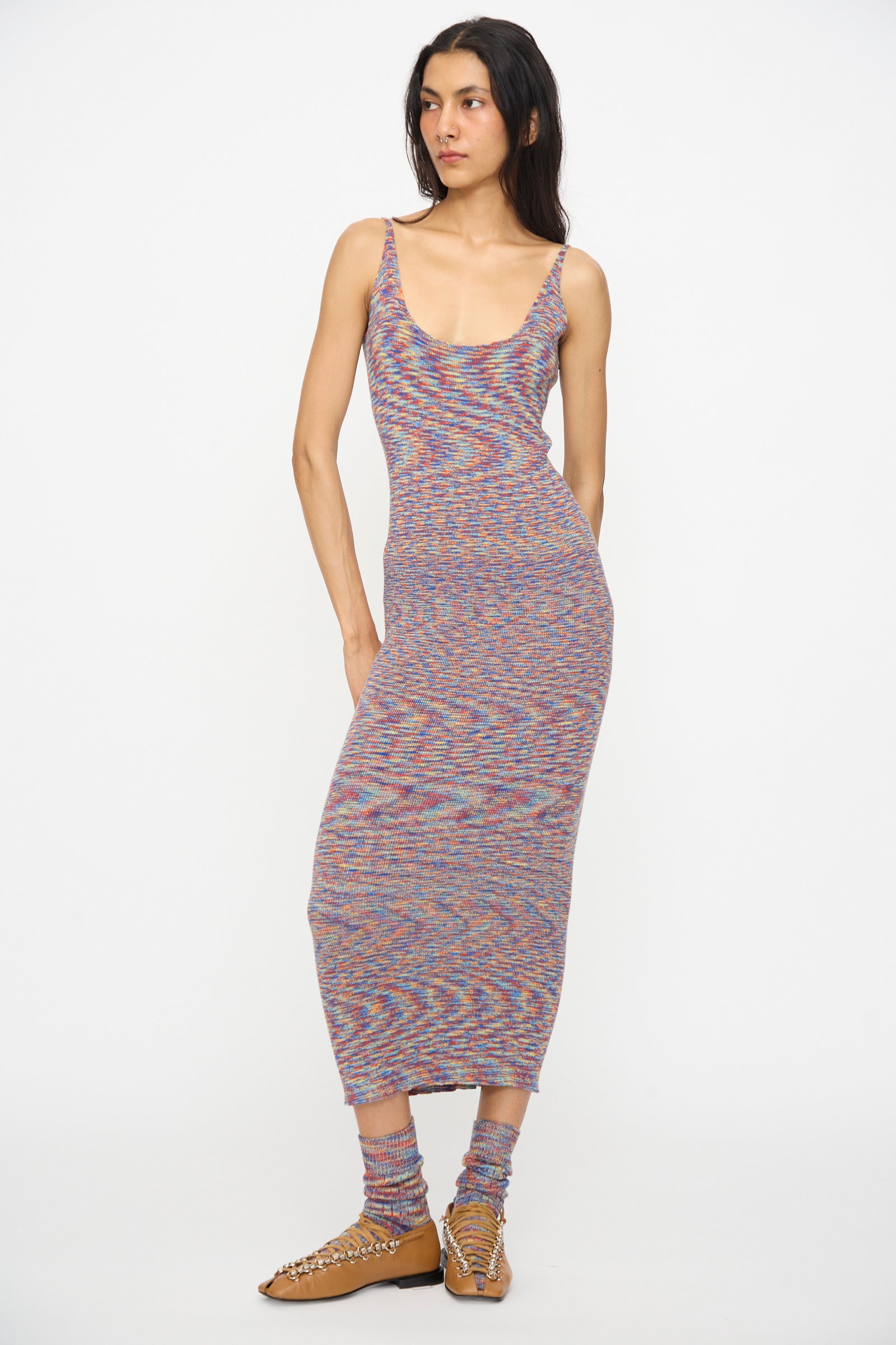A person wears the Baserange Flute Dress in Multicolored, paired with matching socks and tan woven flats, standing against a plain white background.