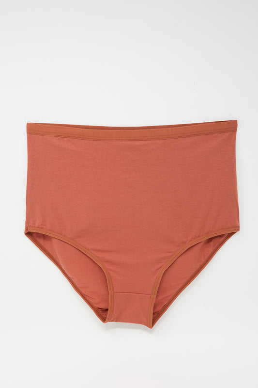 A pair of Baserange Highwaist Bell Pants in Burned Red with elastic trim displayed flat against a white background.