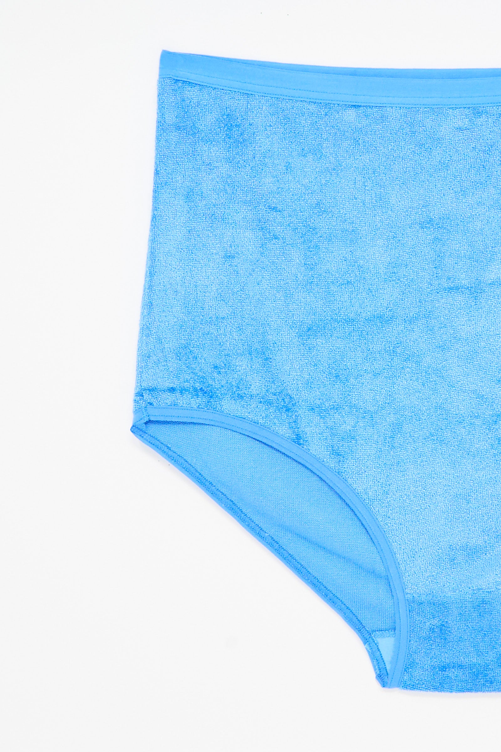 The Baserange Highwaist Bell Pant in Zinn Blue is a pair of high-waisted, light blue terry cloth underpants made from sustainable viscose, shown against a white background.