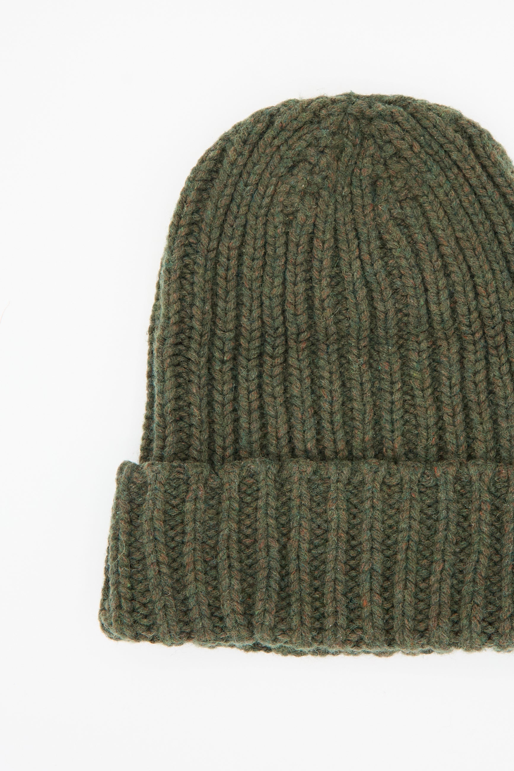 Introducing the Mea Beanie in Foret by Baserange: a green oversized beanie featuring a chunky ribbed texture, crafted from recycled wool, and completed with a folded brim.