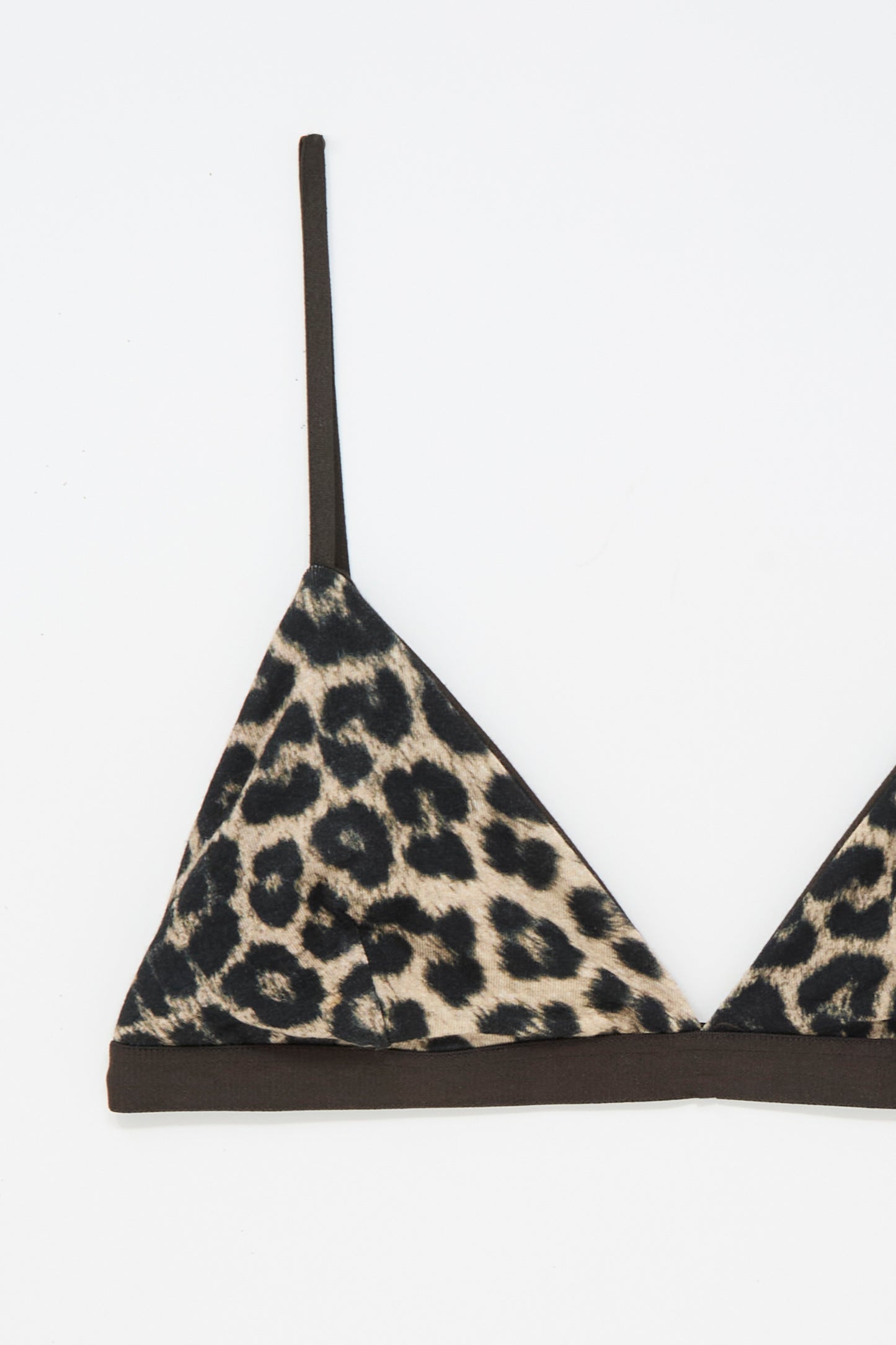 The Baserange Mississippi Bra in Leopard features a modern triangle silhouette with thin black straps, showcased against a white background. Combining style and comfort, this chic bra offers dependable support with its distinctive leopard print design.