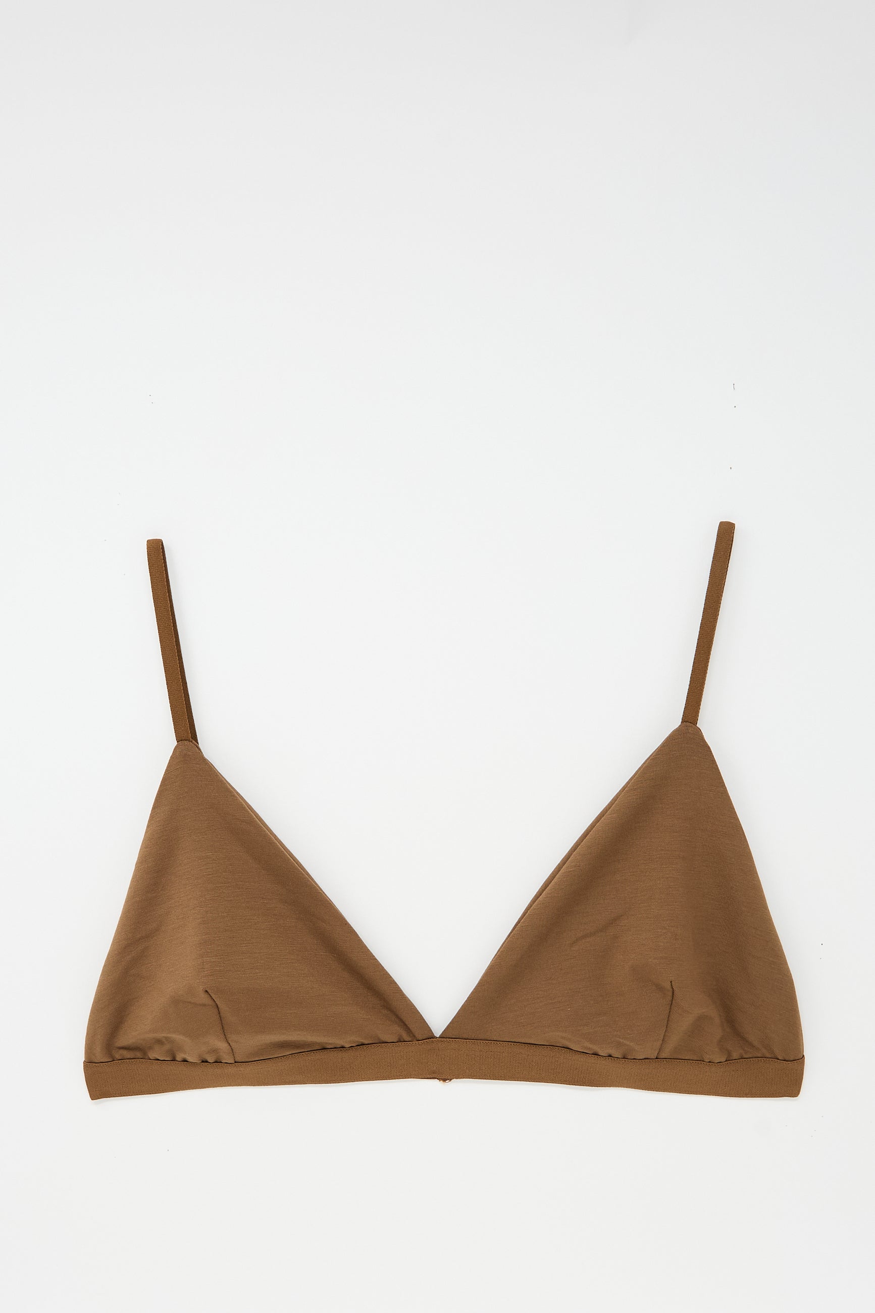 The Mississippi Bra in Ocular by Baserange is a brown, minimalist triangle bra crafted from bamboo lyocell, featuring adjustable thin shoulder straps, laid flat on a white background.