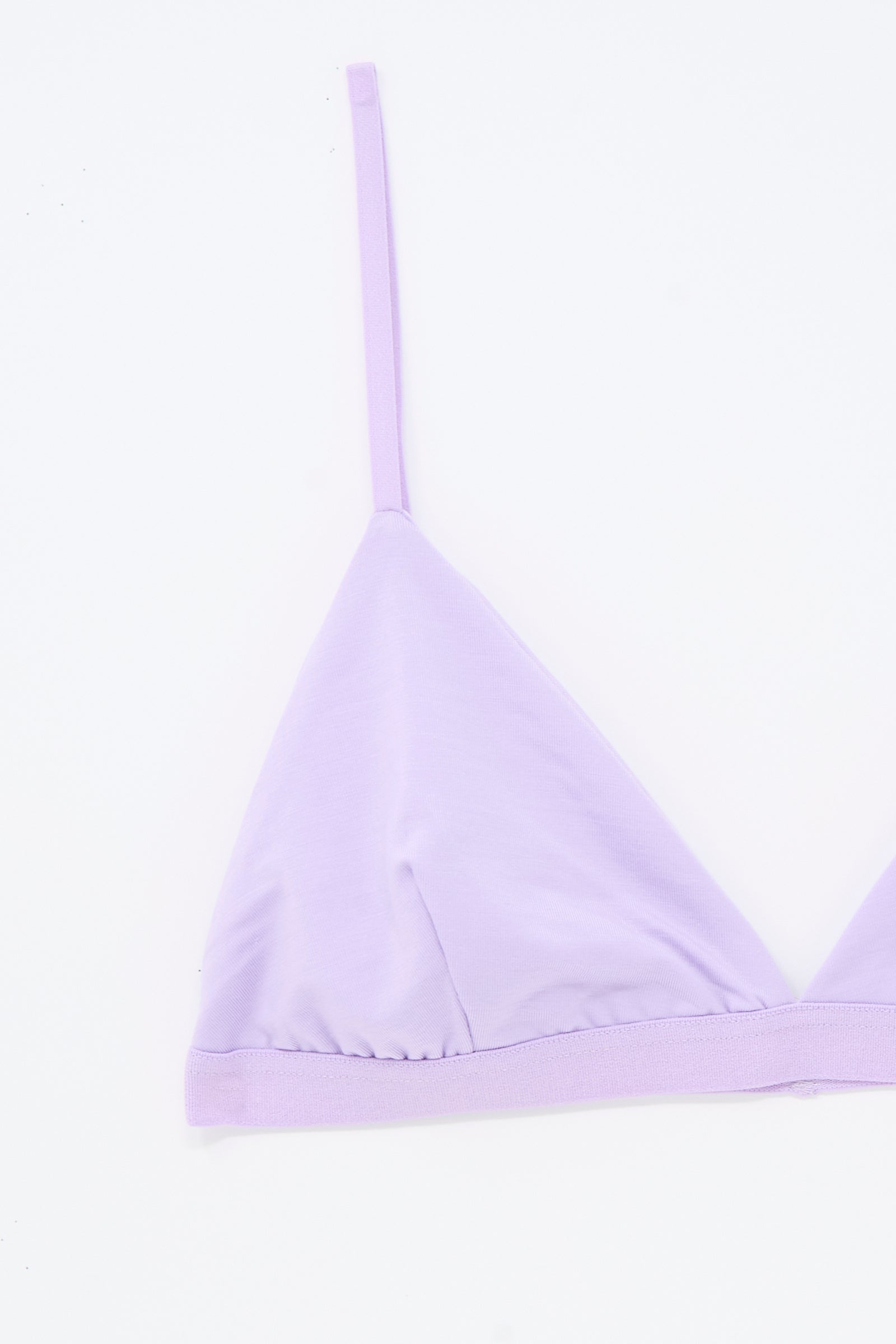 The Baserange Mississippi Bra in One Purple features a lilac triangle bralette design with thin adjustable straps, displayed against a white background. Only the left side of this supportive bra is shown.